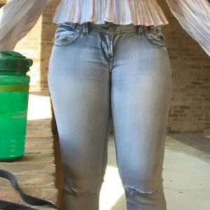 Light wash bell bottom jeans with ripped knees